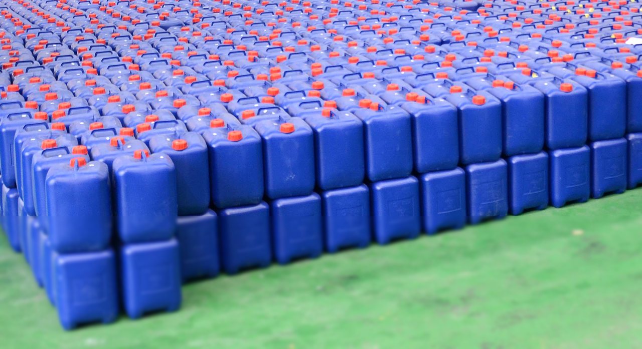 Phosphoric acid packed in blue plastic containers in a warehouse (Illustrative image)